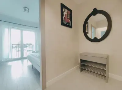 a white room with a mirror and a table at Klimeckiego 8a by Homeprime in Kraków