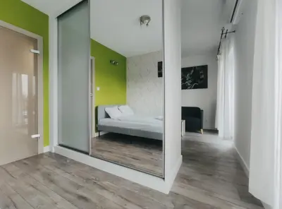 a mirror in a hallway with a couch in a room at Klimeckiego 8a by Homeprime in Kraków