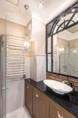 a bathroom with a sink and a mirror at Fragola Apartments Piłsudskiego 11 in Kraków