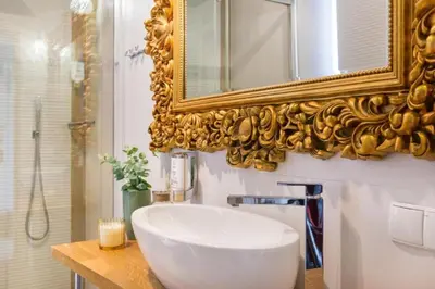 a bathroom with a white sink and a mirror at Fragola Apartments Piłsudskiego 11 in Kraków
