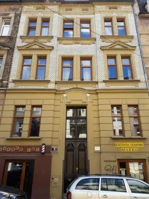 a building with a car parked in front of it at Studio in the center -easy access from the airport in Kraków