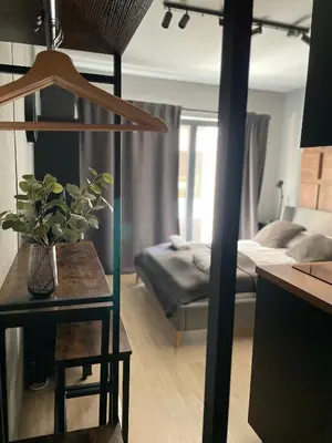 a living room with a bed and a table with a table sidx sidx at Kątowa in Kraków