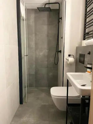 a bathroom with a shower and a toilet and a sink at Kątowa in Kraków