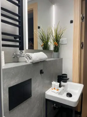 a bathroom with a sink and a mirror at Kątowa in Kraków