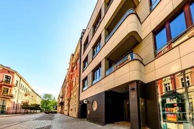 an empty street in front of a building at Apartament 5th floor in Kraków