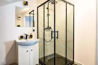 a bathroom with a shower and a sink at Apartament 5th floor in Kraków