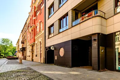 an empty street in front of a building at Apartament 5th floor in Kraków