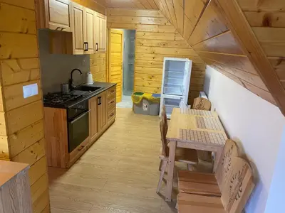 a kitchen with a table and a stove at Domek na Stasince in Sidzina