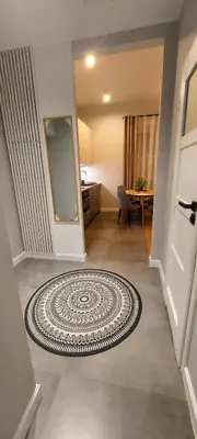 a hallway with a room with a rug on the floor at Apartament Wiejska in Kraków