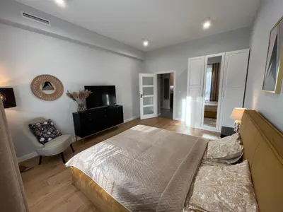 a large bedroom with a bed and a couch at Apartament Wiejska in Kraków