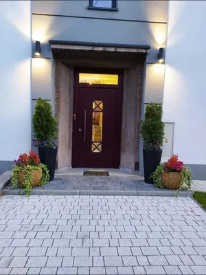 a front door of a house with potted plants at Apartament Wiejska in Kraków