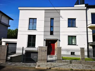 a white house with a red door at Apartament Wiejska in Kraków