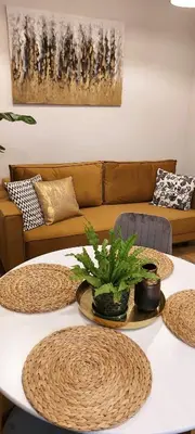 a living room with a couch and a table at Apartament Wiejska in Kraków