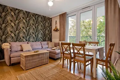 a living room with a couch and a table at Cracow Wroclawska Premium Apartment in Kraków