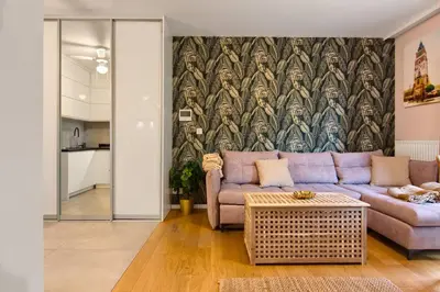 a living room with a purple couch and a wall mural at Cracow Wroclawska Premium Apartment in Kraków