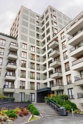 a large white building with stairs in front of it at Cracow Wroclawska Premium Apartment in Kraków
