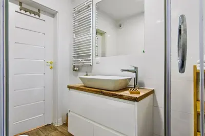 a bathroom with a sink and a mirror at Cracow Wroclawska Premium Apartment in Kraków