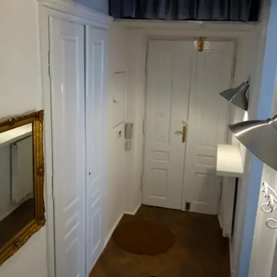 a bedroom with a large bed with clocks on the wall at Sebastian Gold in Kraków