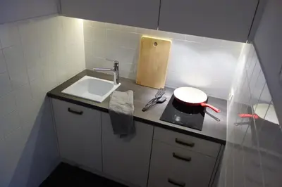 a small bathroom with a sink and a counter at Sebastian Gold in Kraków