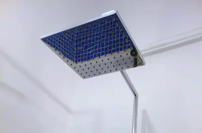 a bathroom with a mirror and blue tiles at Sebastian Gold in Kraków