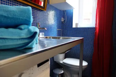 a bathroom with a sink and a mirror and towels at Sebastian Gold in Kraków