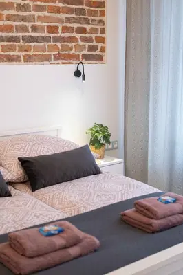 two beds with towels on them in a bedroom at Old Town Zamkowa vis a vis Wawelu in Kraków