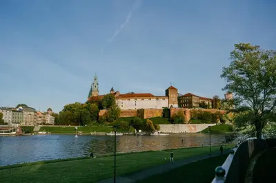 a view of a large building next to a body of water at Old Town Zamkowa vis a vis Wawelu in Kraków