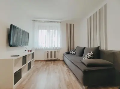 a living room with a couch and a flat screen tv at Pielęgniarek 5 by Homeprime in Kraków