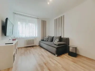 a living room with a couch and a flat screen tv at Pielęgniarek 5 by Homeprime in Kraków