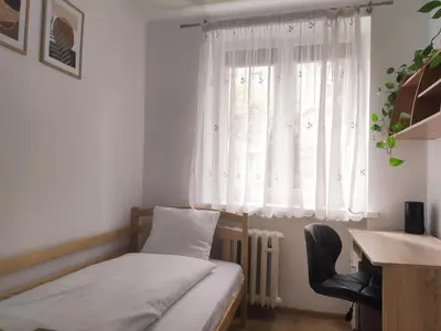 a room with a bed and a desk and a window at Pielęgniarek 5 by Homeprime in Kraków