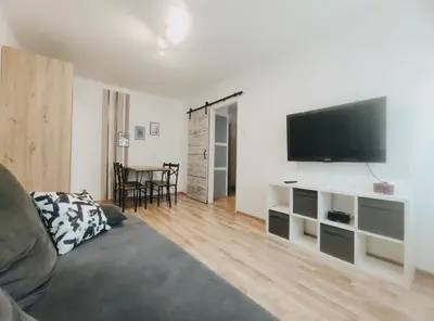 a living room with a couch and a flat screen tv at Pielęgniarek 5 by Homeprime in Kraków