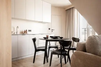 a kitchen and dining room with a table and chairs at Rooftop Apartment with Terrace by T in Kraków
