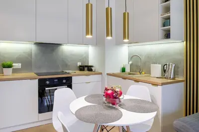 a kitchen with a table with a bowl of fruit on it at In Gold Apartment in Kraków