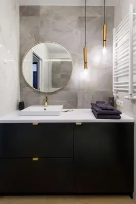 a bathroom with a sink and a mirror at In Gold Apartment in Kraków