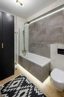 a bathroom with a toilet and a tub and a sink at In Gold Apartment in Kraków