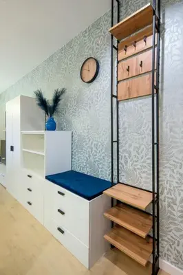 a room with a closet with white cabinets and a shelf at In Blue Apartment in Kraków
