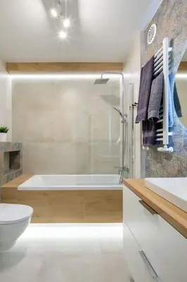 a bathroom with a tub and a toilet and a sink at In Blue Apartment in Kraków