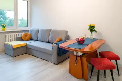a living room with a couch and a table at Poczuj się jak u siebie w domu in Kraków