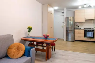 a bedroom with a bed and a table and a window at Poczuj się jak u siebie w domu in Kraków