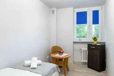 a living room with a table and a kitchen at Poczuj się jak u siebie w domu in Kraków