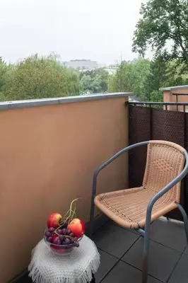 a small room with a bed and a table with a bowl of fruit at Poczuj się jak u siebie w domu in Kraków