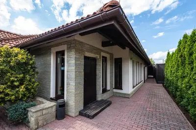 a house with a brick walkway in front of it at Hotel i Restauracja Stara Kuźnia in Dobczyce
