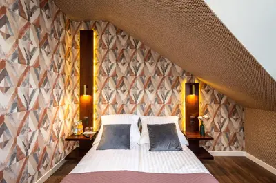 a bedroom with a large bed and two night stands at Hotel i Restauracja Stara Kuźnia in Dobczyce