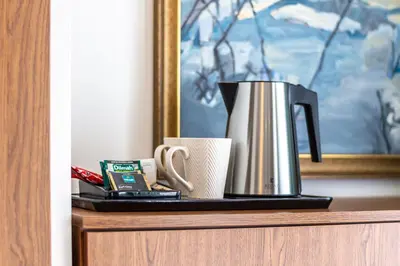 a coffee pot and a cup on a shelf at Hotel i Restauracja Stara Kuźnia in Dobczyce