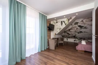 a living room with a painting on the wall at Hotel i Restauracja Stara Kuźnia in Dobczyce