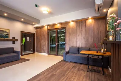a lobby with two blue couches and a table at Hotel i Restauracja Stara Kuźnia in Dobczyce