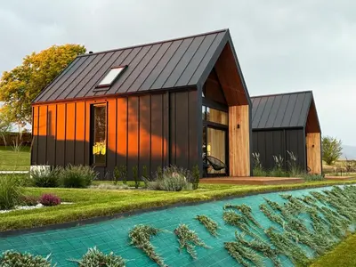 an orange and black house with a black roof at NALAS domki z widokiem in Rabka