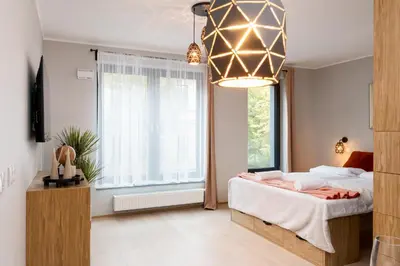 a bedroom with a bed and a large window at Malila Premium Apartments Cracow Centre Grzegórzecka 15 in Kraków