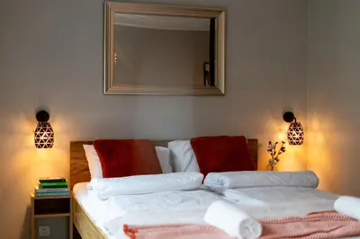 a bedroom with two beds and a mirror on the wall at Malila Premium Apartments Cracow Centre Grzegórzecka 15 in Kraków