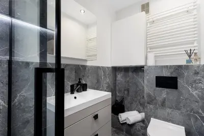 a bathroom with a white sink and a toilet at Malila Premium Apartments Cracow Centre Grzegórzecka 15 in Kraków